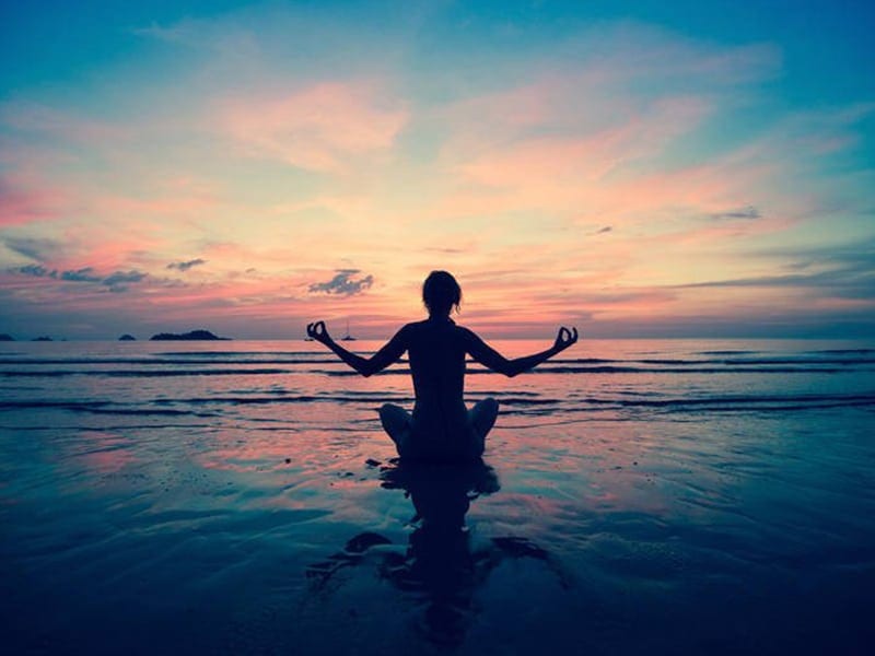 image of lady sitting in water meditating