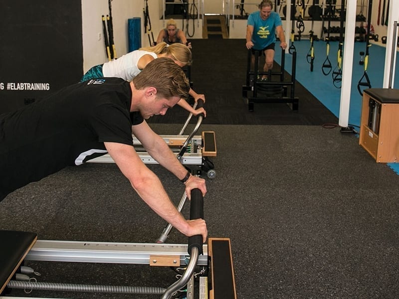 Image of clients on pilates beds