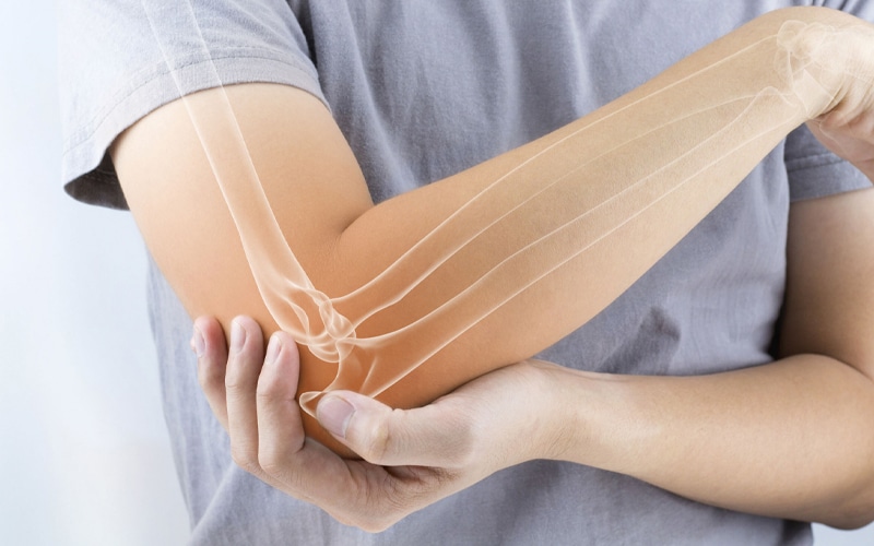 holding elbow in pain