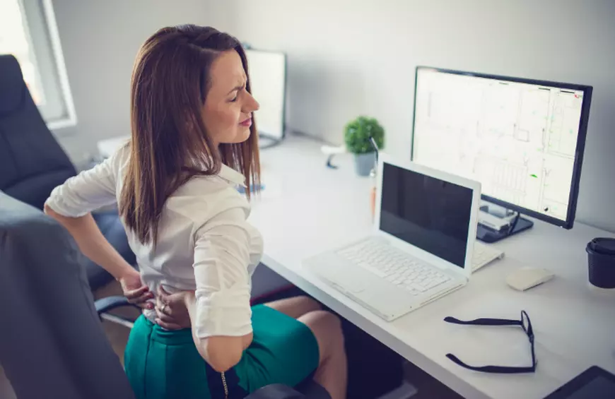 lady sitting in chair with sore back